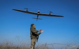 A Ukrainian serviceman launches a mid-range reconnaissance drone 